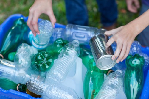 Business staff separating recyclables in a back-of-house area